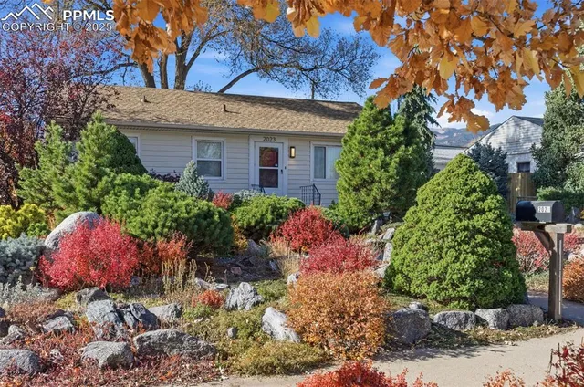 a view of a house with a yard and garden
