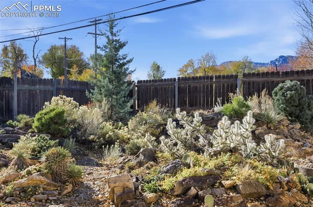 a view of a garden with a house