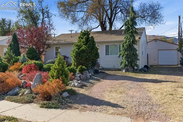 a view of a house with a yard and pathway