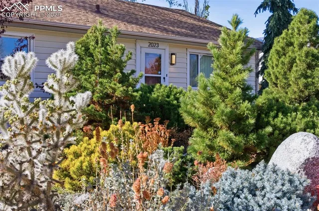 a view of a house with potted plants