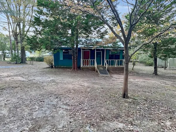 a view of a house with a backyard