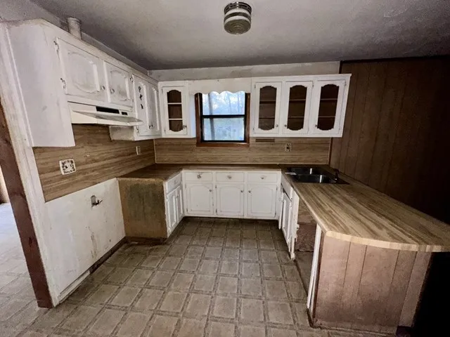 a kitchen with a sink and cabinets
