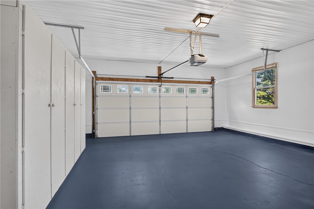 103 Dorsey Lane Walhalla, SC 29691 - Photo 23 of 42 Functional garage with a durable blue floor, featuring built-in storage and a window for natural light.