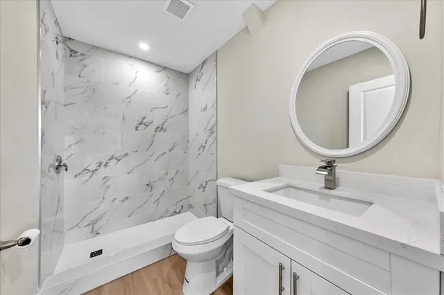 a bathroom with a sink toilet and shower