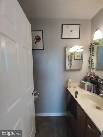 a bathroom with a sink toilet and mirror