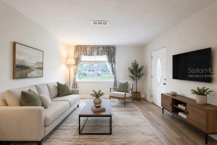 314 4th Avenue Southwest Ruskin, FL 33570 - Photo 2 of 30 a living room with furniture and a flat screen tv