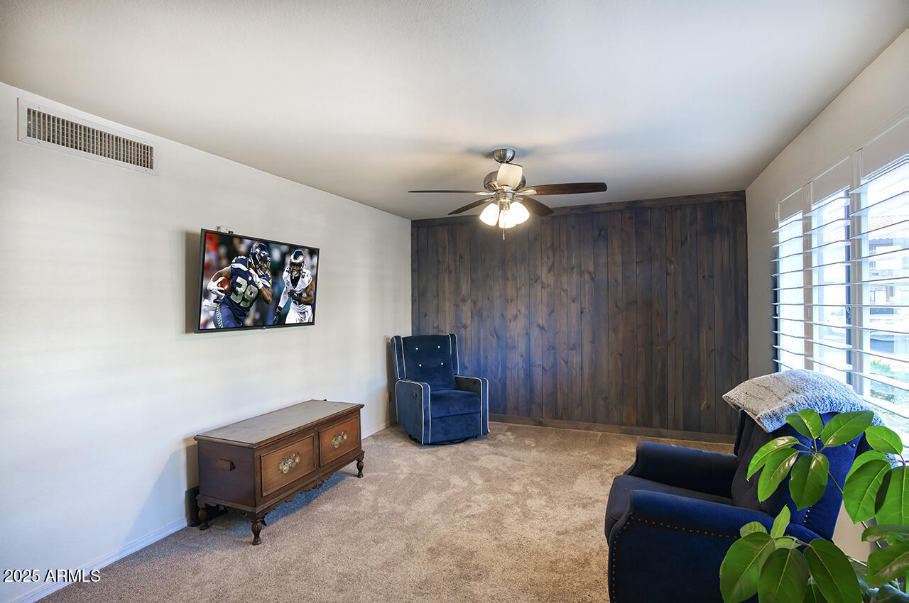 1402 East Guadalupe Road, Unit 149 Tempe, AZ 85283 - Photo 3 of 16 a living room with furniture and a chandelier