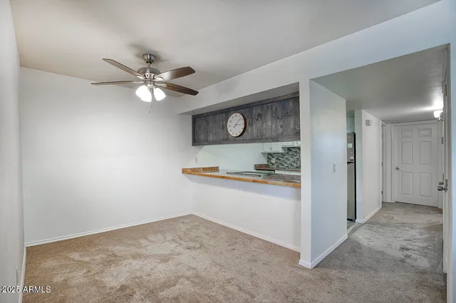 a view of kitchen with stainless steel appliances granite countertop cabinets and fireplace