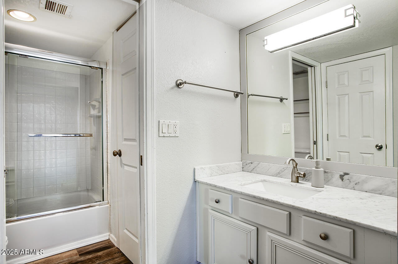 1402 East Guadalupe Road, Unit 149 Tempe, AZ 85283 - Photo 10 of 16 a bathroom with a shower sink vanity and mirror