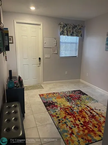 a living room with furniture and a rug