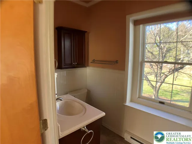 an empty room with windows and fireplace