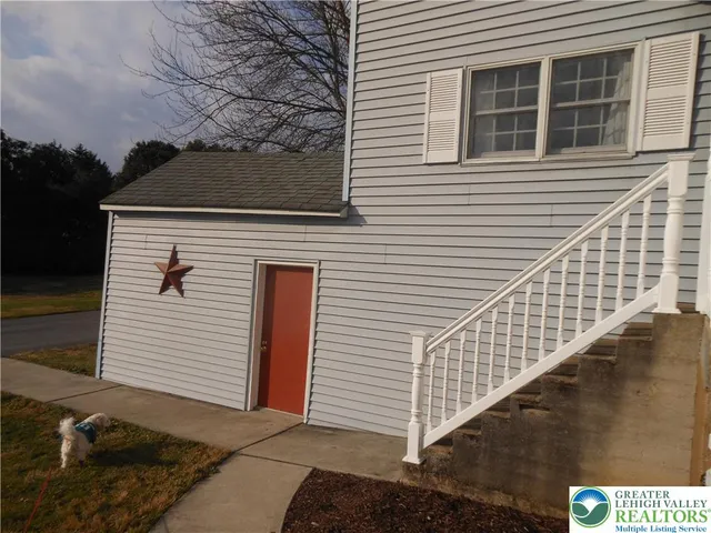 a view of a house with snow on the side of it