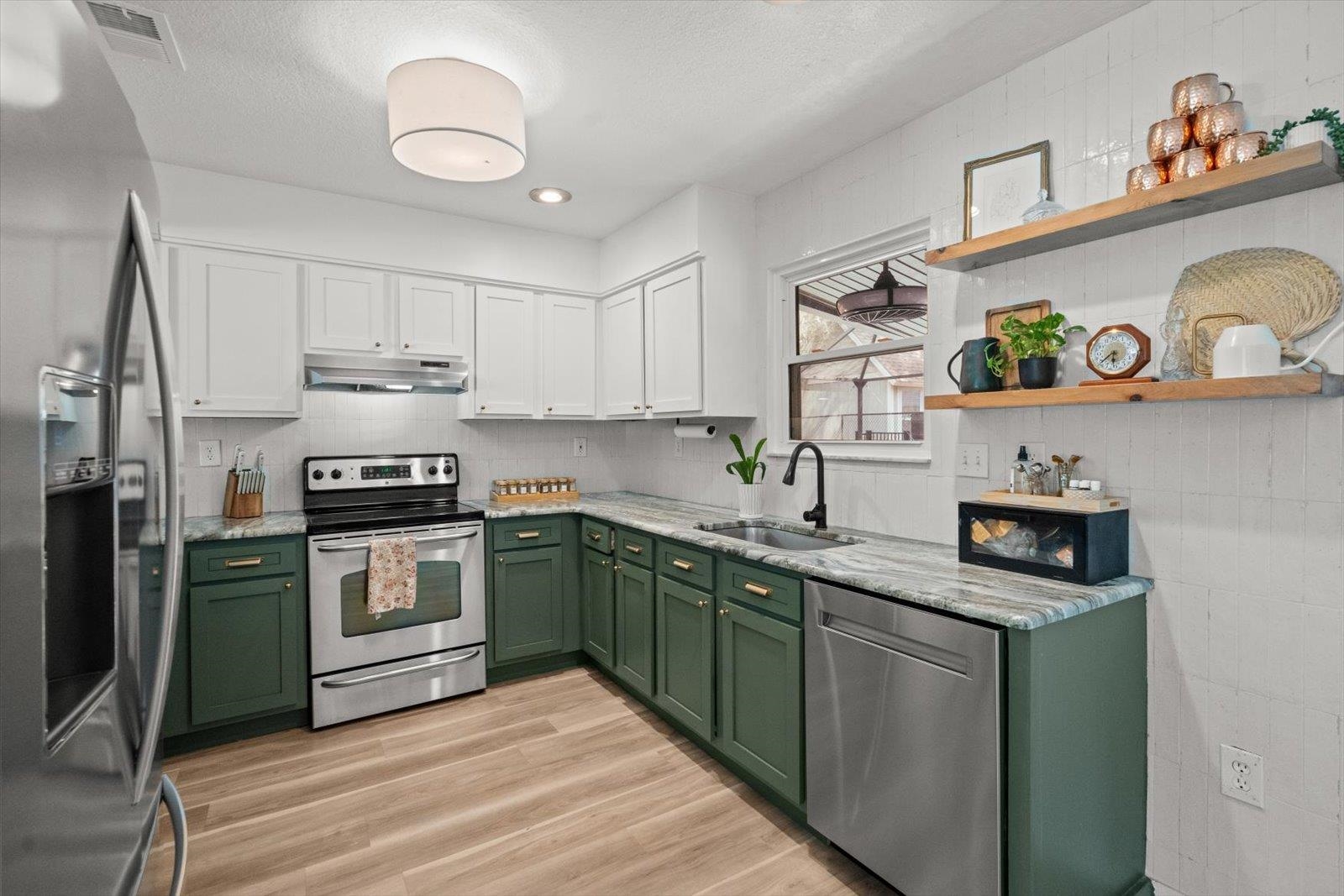 135 Orchis Road St. Augustine, FL 32086 - Photo 26 of 50 a kitchen with stainless steel appliances granite countertop a sink and cabinets