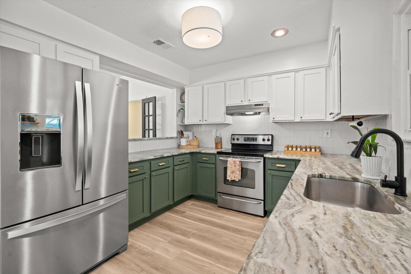 135 Orchis Road St. Augustine, FL 32086 - Photo 28 of 50 a kitchen with a refrigerator sink and stainless steel appliances