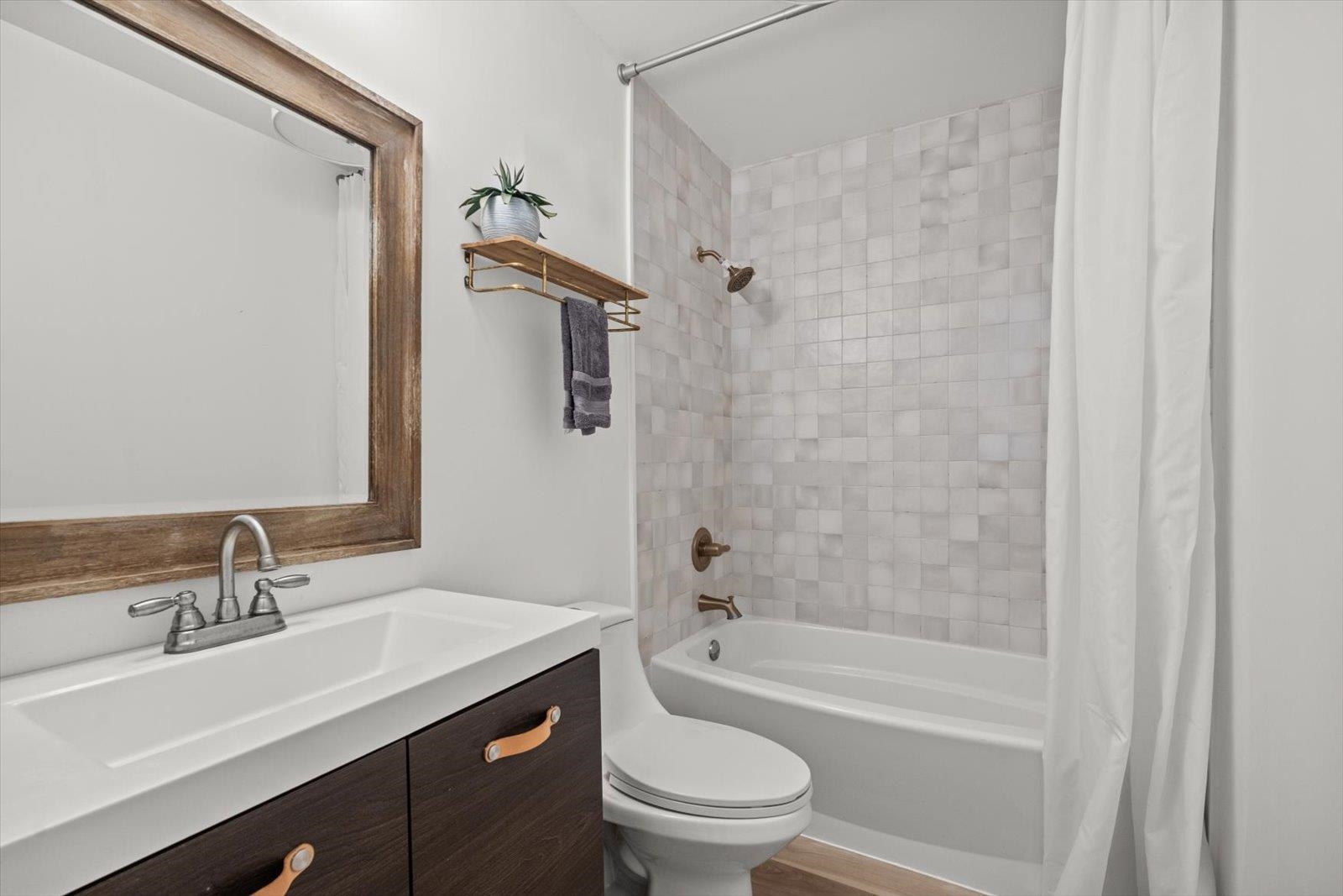 135 Orchis Road St. Augustine, FL 32086 - Photo 31 of 50 a bathroom with a sink a toilet a mirror a bathtub and shower