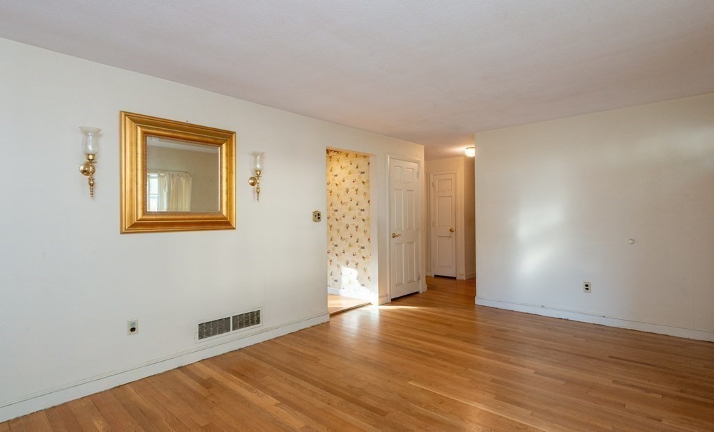 91 Brookside Road Lynn, MA 01902 - Photo 11 of 28 a view of an empty room with wooden floor and a window