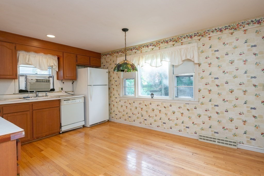 91 Brookside Road Lynn, MA 01902 - Photo 13 of 28 a kitchen with granite countertop white cabinets a refrigerator and a stove