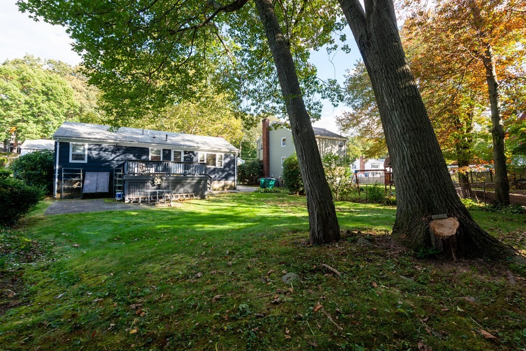 91 Brookside Road Lynn, MA 01902 - Photo 28 of 28 a view of a trees in a yard with a bench