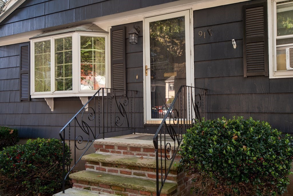 91 Brookside Road Lynn, MA 01902 - Photo 3 of 28 a view of a house with a large window and flower plants