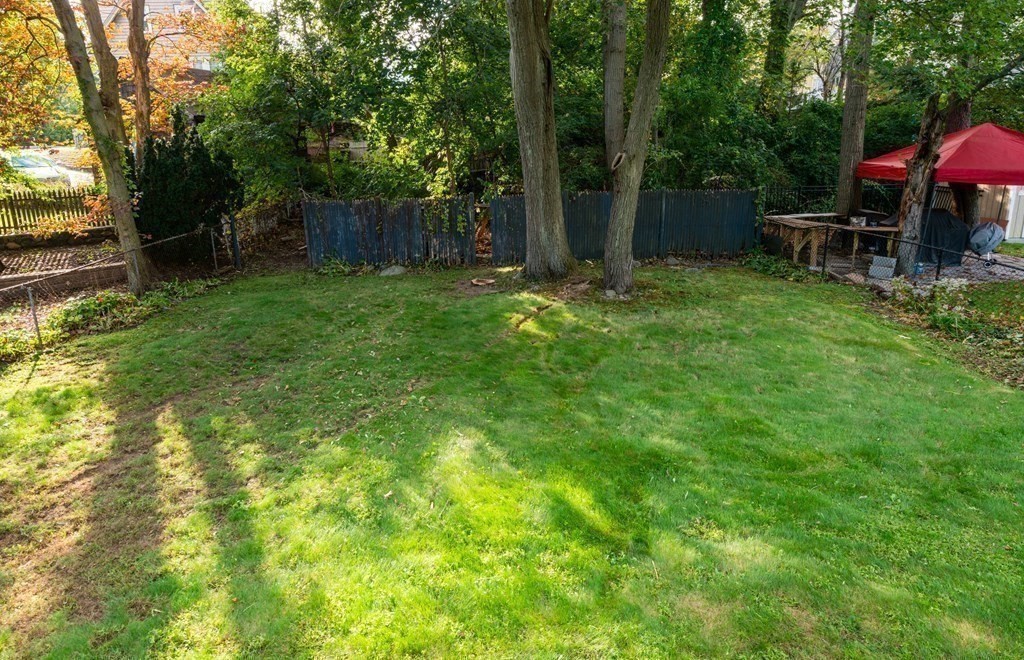 91 Brookside Road Lynn, MA 01902 - Photo 5 of 28 a view of backyard with table and chairs and a large tree