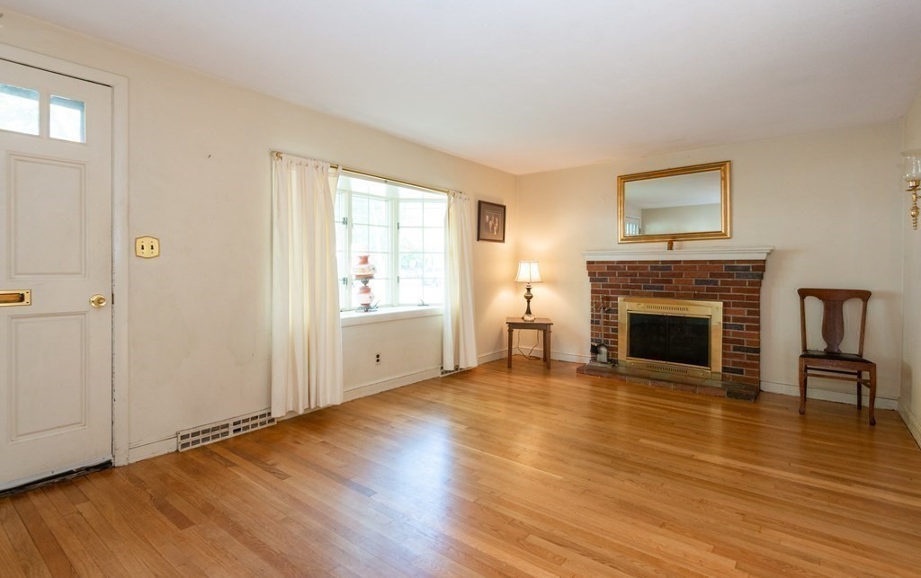 91 Brookside Road Lynn, MA 01902 - Photo 8 of 28 a view of a livingroom with wooden floor and a fireplace