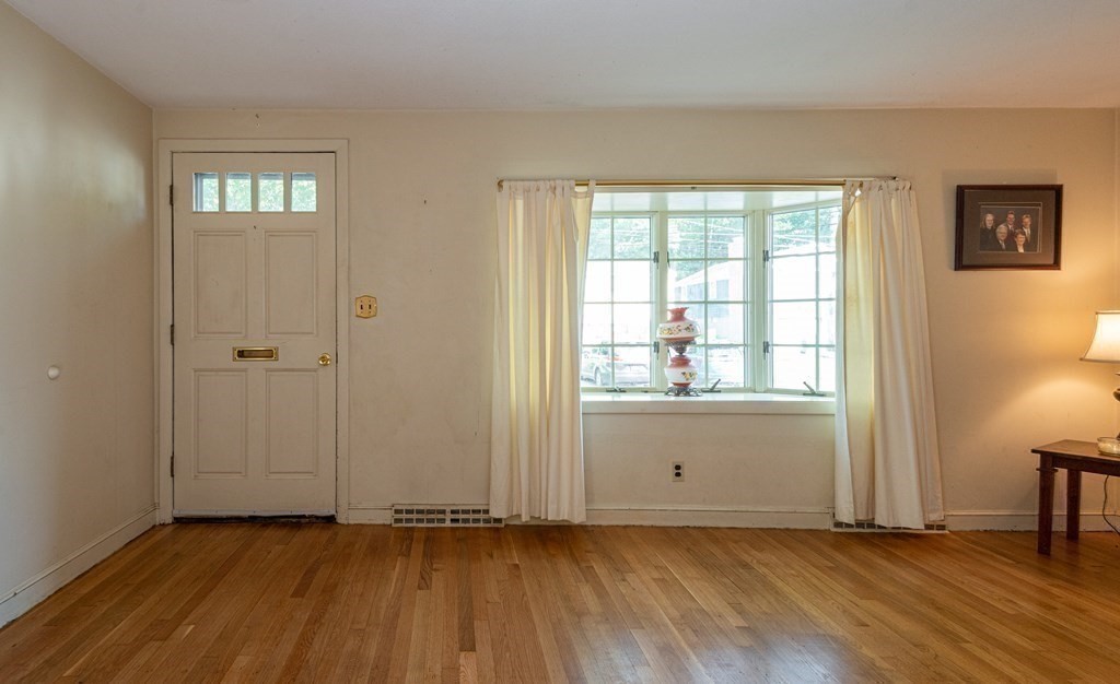 91 Brookside Road Lynn, MA 01902 - Photo 9 of 28 an empty room with wooden floor and windows