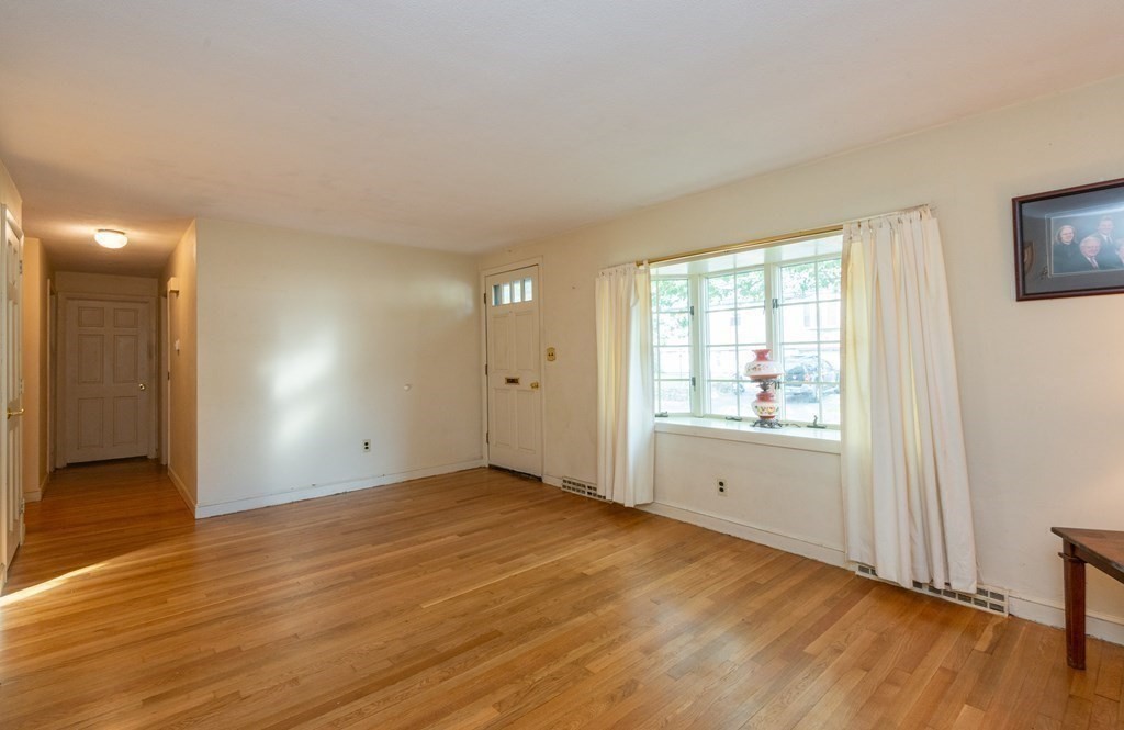 91 Brookside Road Lynn, MA 01902 - Photo 10 of 28 an empty room with wooden floor and windows
