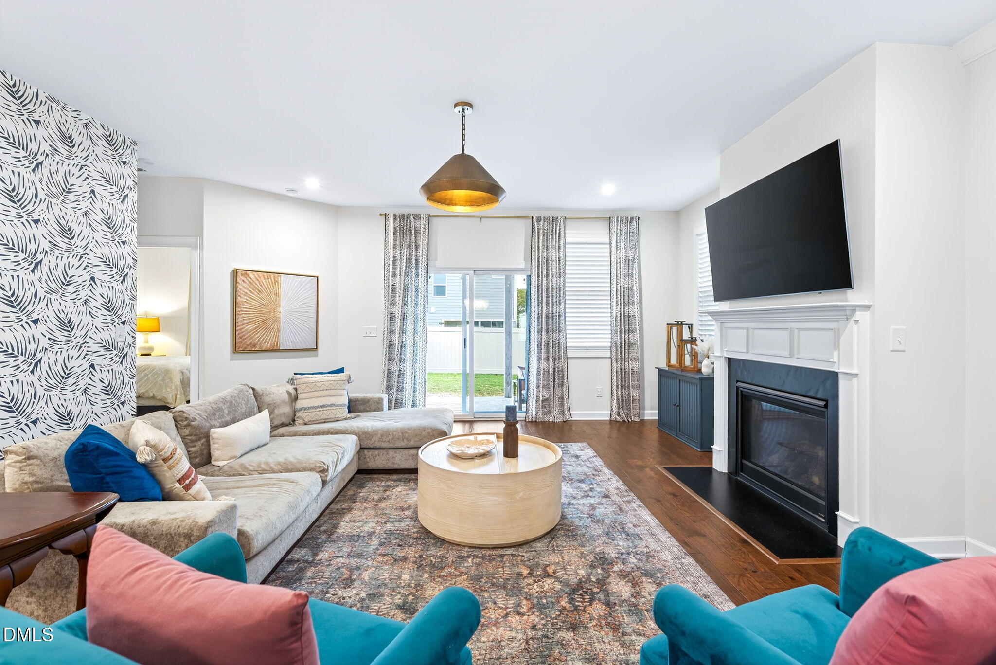 2928 Murray Rdg Trail Apex, NC 27502 - Photo 11 of 35 a living room with furniture a fireplace and a flat screen tv