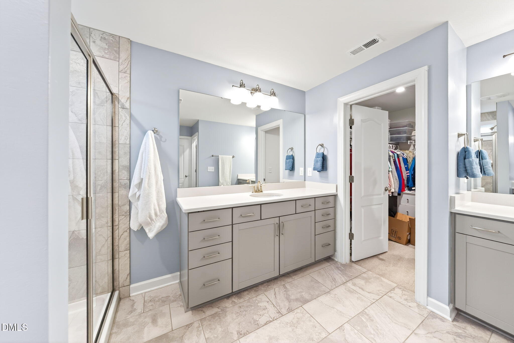 2928 Murray Rdg Trail Apex, NC 27502 - Photo 17 of 35 a spacious bathroom with a double vanity sink and a mirror