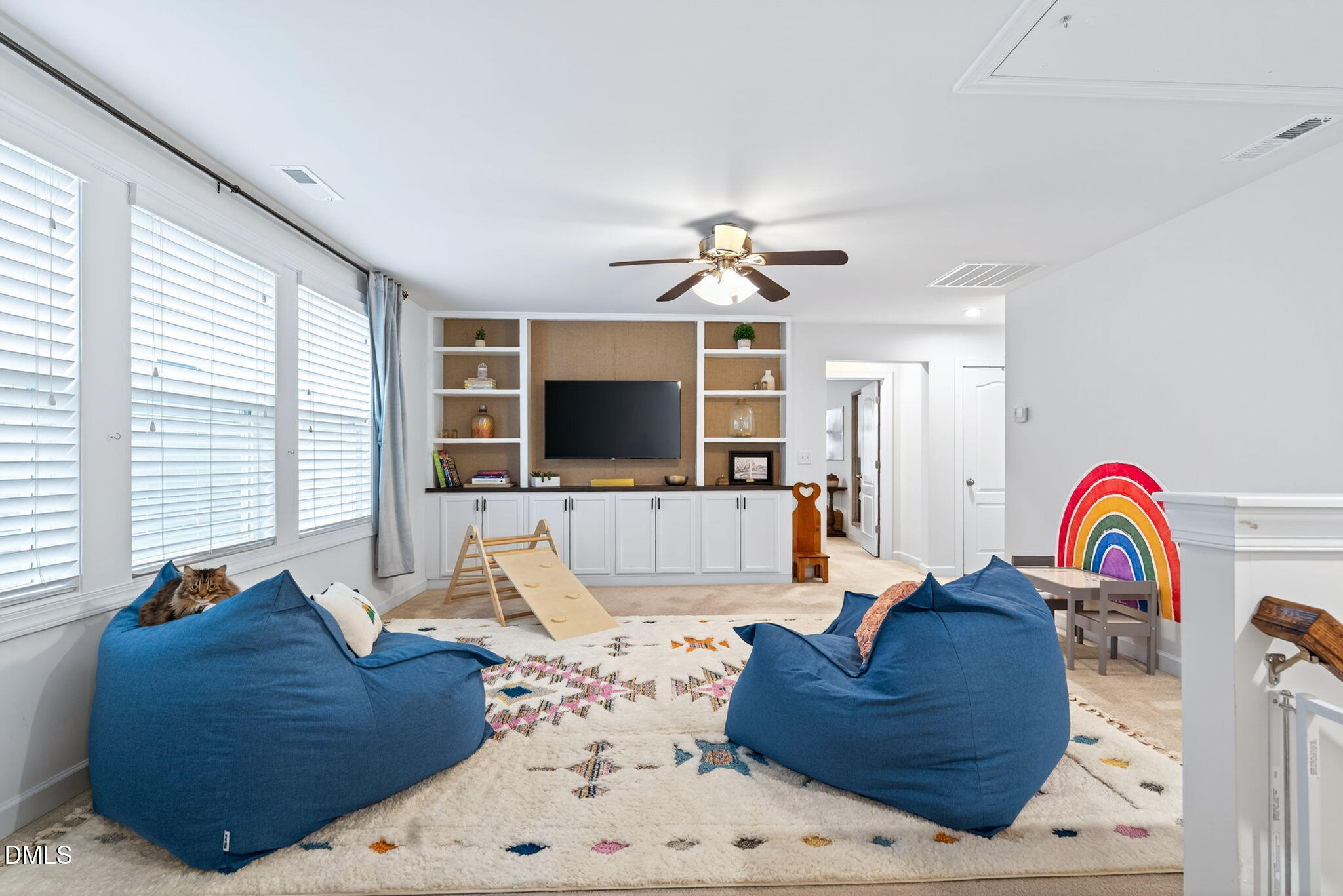 2928 Murray Rdg Trail Apex, NC 27502 - Photo 20 of 35 a living room with furniture ceiling fan and a flat screen tv