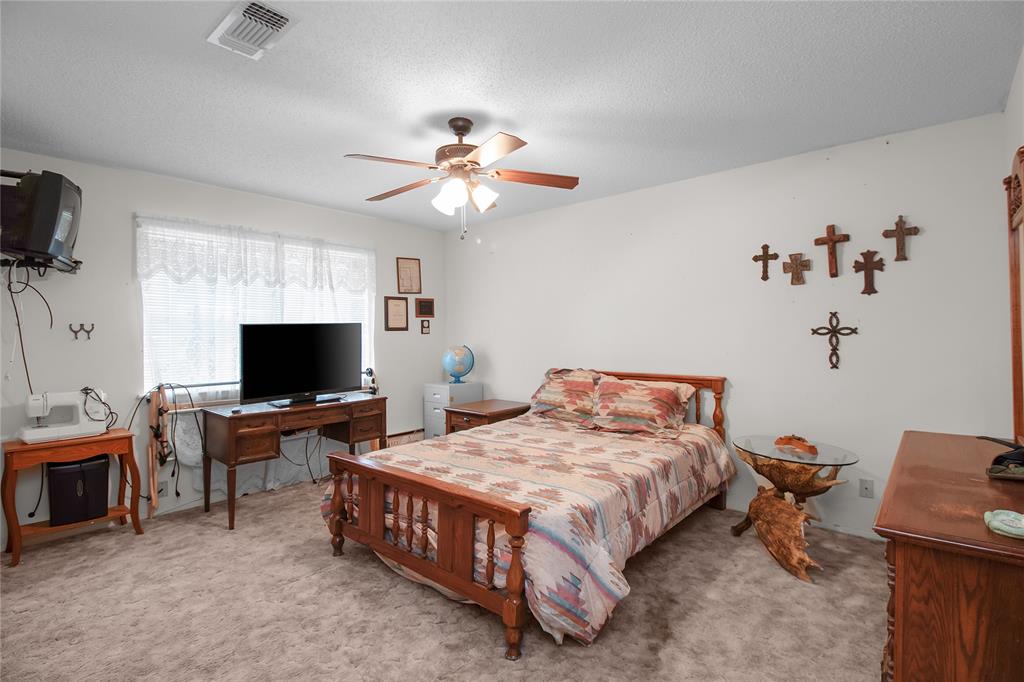 2102 County Road 233 Ballinger, TX 76821 - Photo 11 of 16 a bedroom with a bed and a flat screen tv