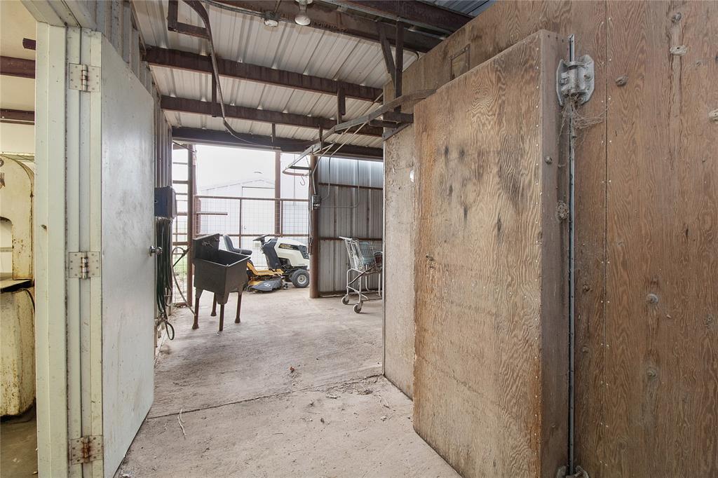 2102 County Road 233 Ballinger, TX 76821 - Photo 13 of 16 a view of a hallway with a dining room and chandelier