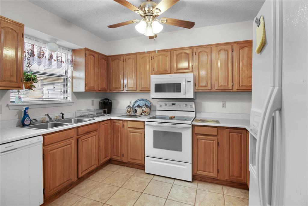 2102 County Road 233 Ballinger, TX 76821 - Photo 4 of 16 a kitchen with stainless steel appliances granite countertop a sink and cabinets