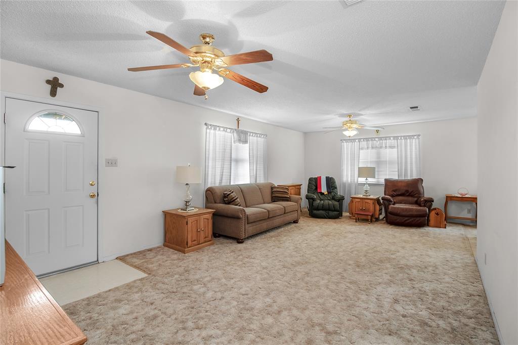 2102 County Road 233 Ballinger, TX 76821 - Photo 7 of 16 a living room with furniture and a chandelier