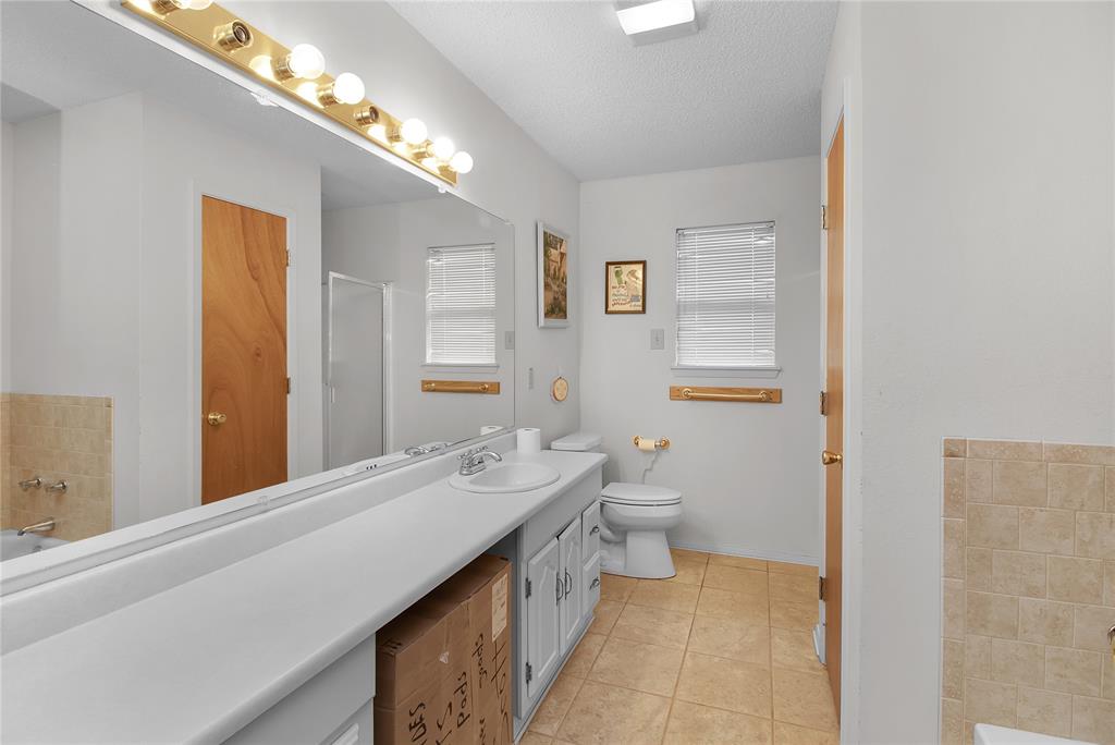 2102 County Road 233 Ballinger, TX 76821 - Photo 9 of 16 a bathroom with a double vanity sink mirror and toilet