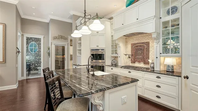 a kitchen with a table chairs and chandelier