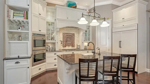 a kitchen with cabinets a center island and stainless steel appliances
