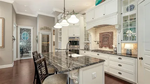 a kitchen with a table chairs and chandelier