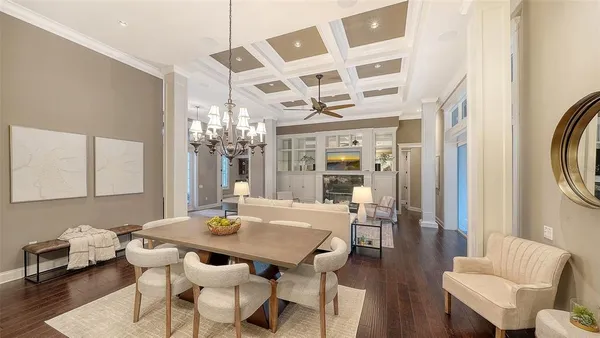 a dining room with a wooden table and chairs