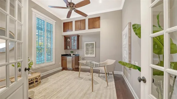 a living room with couch cabinets and a window