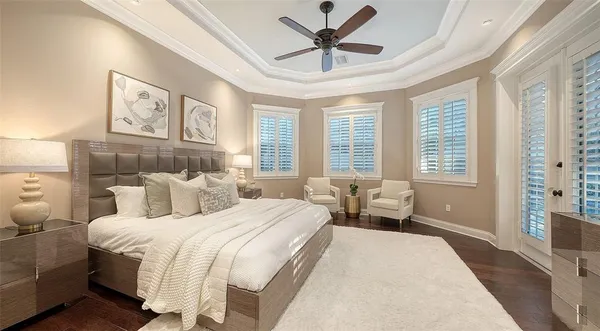a bedroom with a bed and a large window
