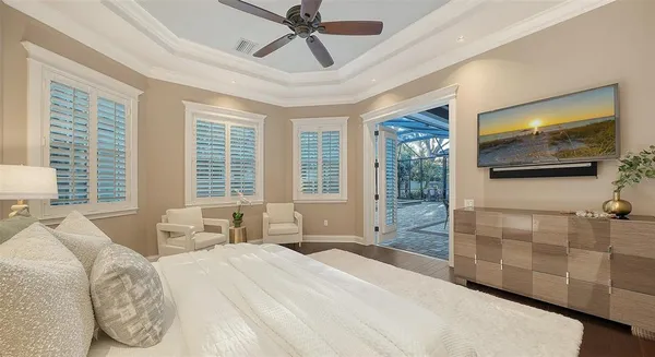 a bedroom with a bed and a chandelier