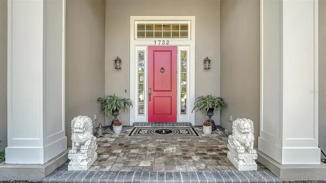 a view of porch with a table and chairs