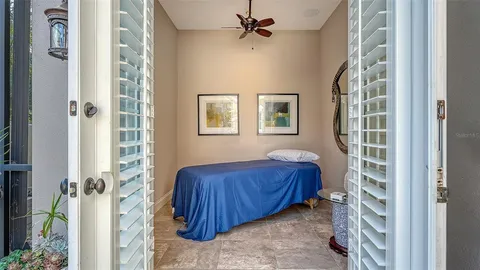 a bedroom with a bed and a mirror