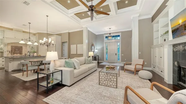 a kitchen with stainless steel appliances kitchen island granite countertop a table chairs and a refrigerator