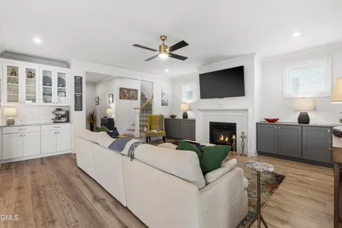a living room with furniture a fireplace and a flat screen tv