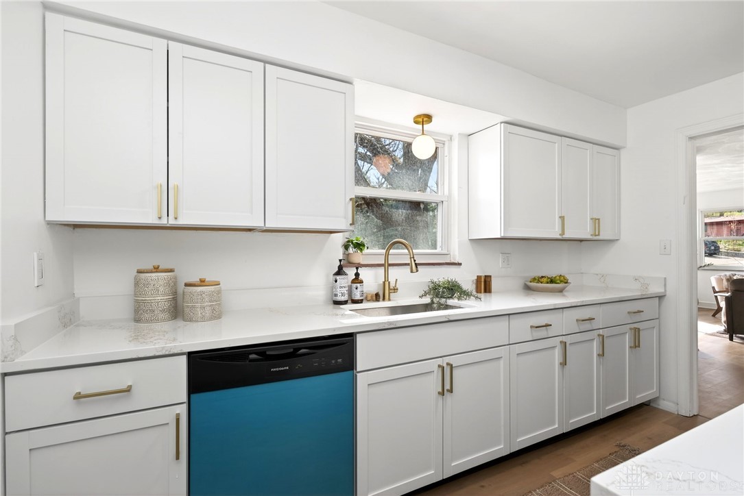 1243 Ridgeview Avenue Dayton, OH 45409 - Photo 17 of 56 This bright kitchen features sleek white cabinetry and a modern sink, perfect for culinary endeavors.