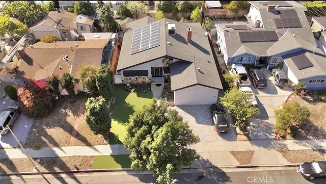 an aerial view of a house with a yard and garden