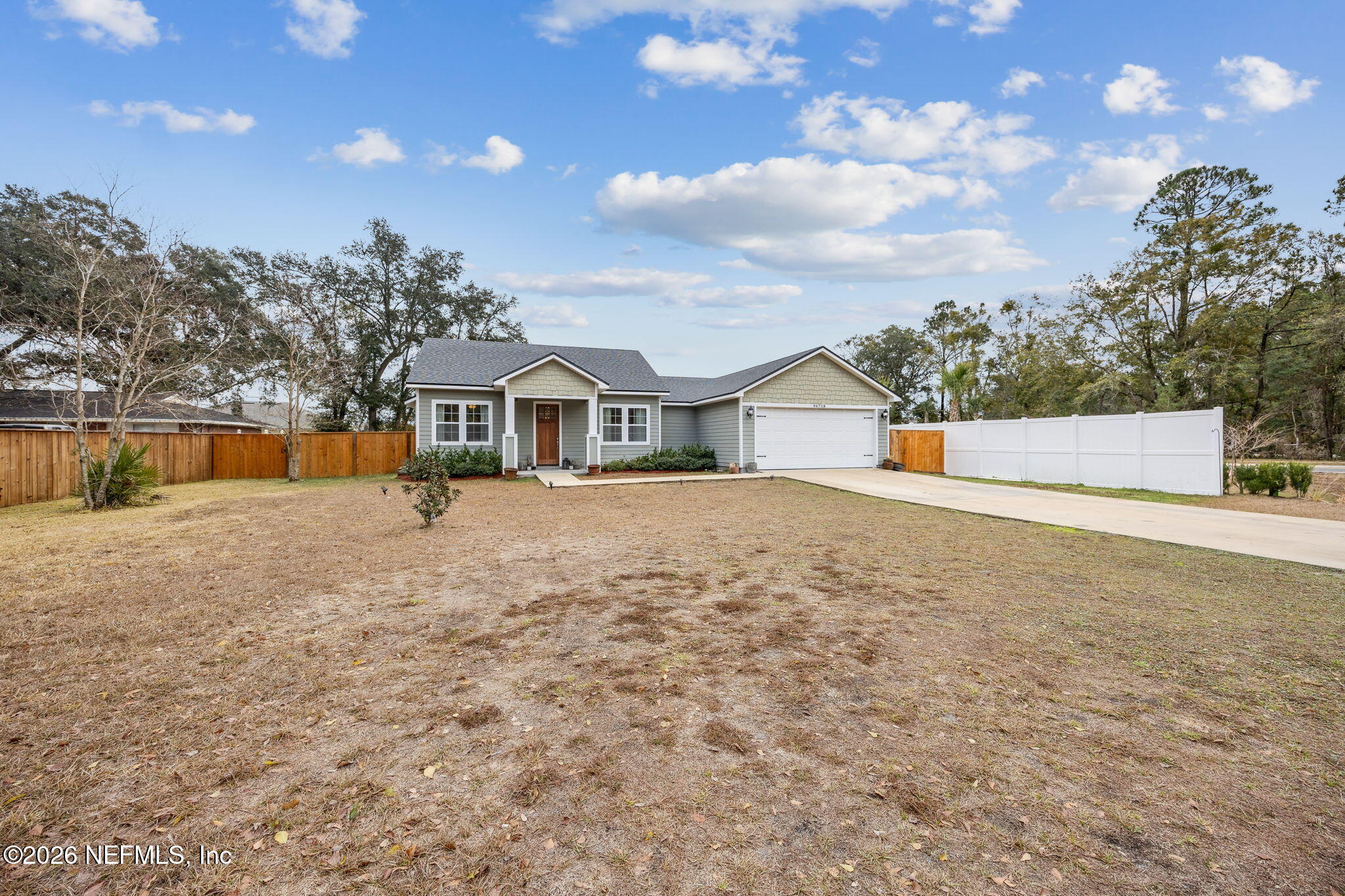 96718 Blackrock Road Yulee, FL 32097 - Photo 11 of 54 a front view of a house with a yard