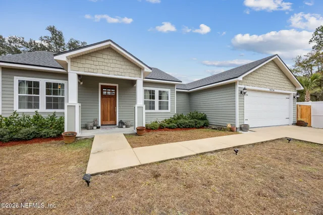 a view of a livingroom with wooden floor and a flat screen tv